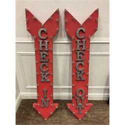 Two painted metal “check in”, “check out”, light up signs 