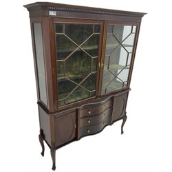 Late 19th century mahogany display cabinet on stand, projecting dentil cornice, fitted with two astragal glazed doors, base with three central serpentine fronted drawers, flanked by oval panelled cupboard, on cabriole supports