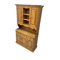 Pine farmhouse dresser, raised back with two cupboards flanking open shelves, above three drawers and three cupboards