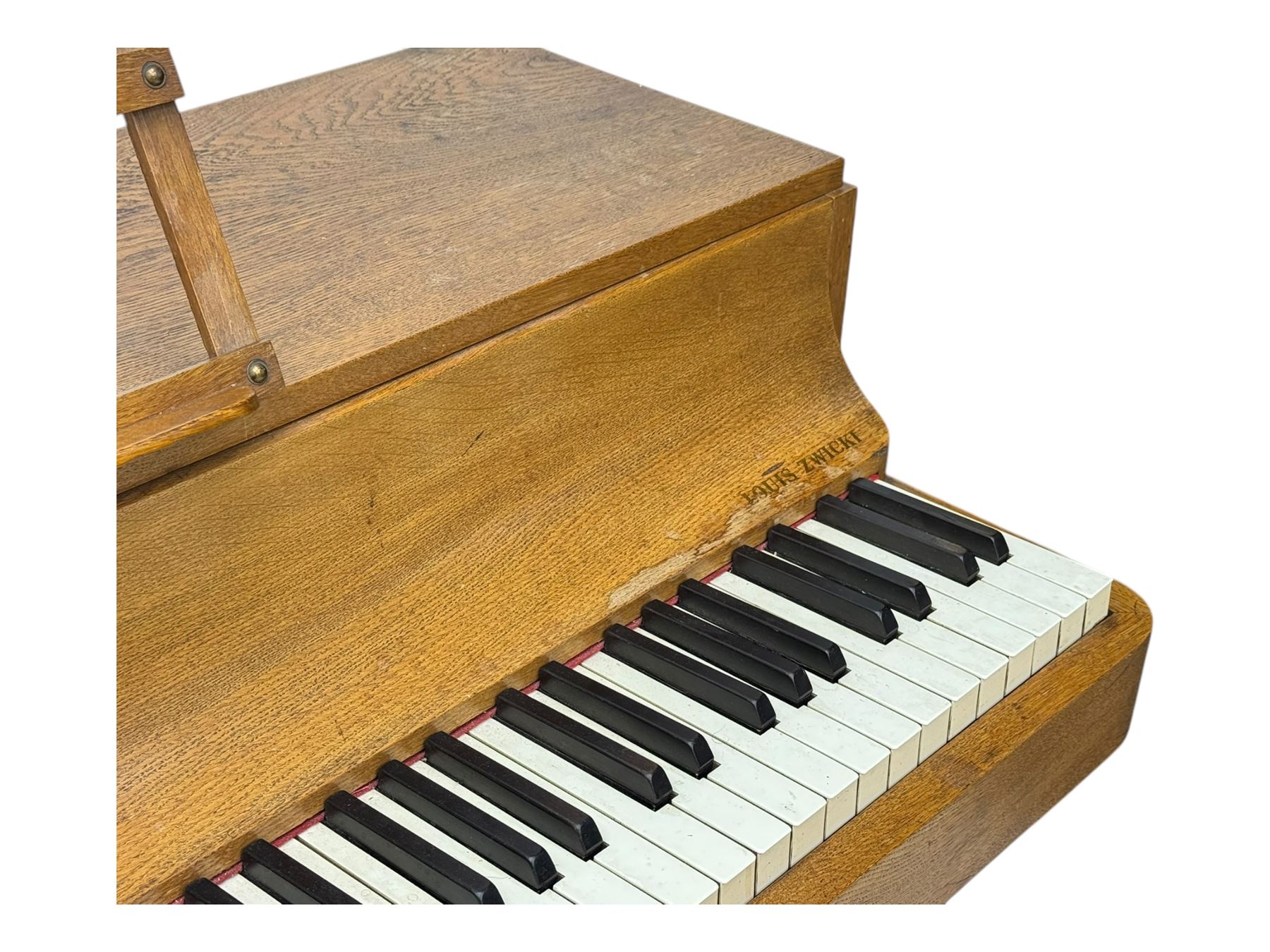 Louis Zwicki - mid-20th century oak cased compact piano, fitted with a folding music rest and full keyboard, dual brass pedals