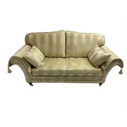 Steed Upholstery - two seat traditional shaped sofa, upholstered in cream fabric with stripe pattern, on turned front feet with brass castors, with side cushions and arm covers