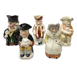 19th century and later Toby jugs comprising Staffordshire Punch and Judy jugs, Victorian 'I am on the black list' jug, two jugs in the form of Toby with a jug of beer (5)