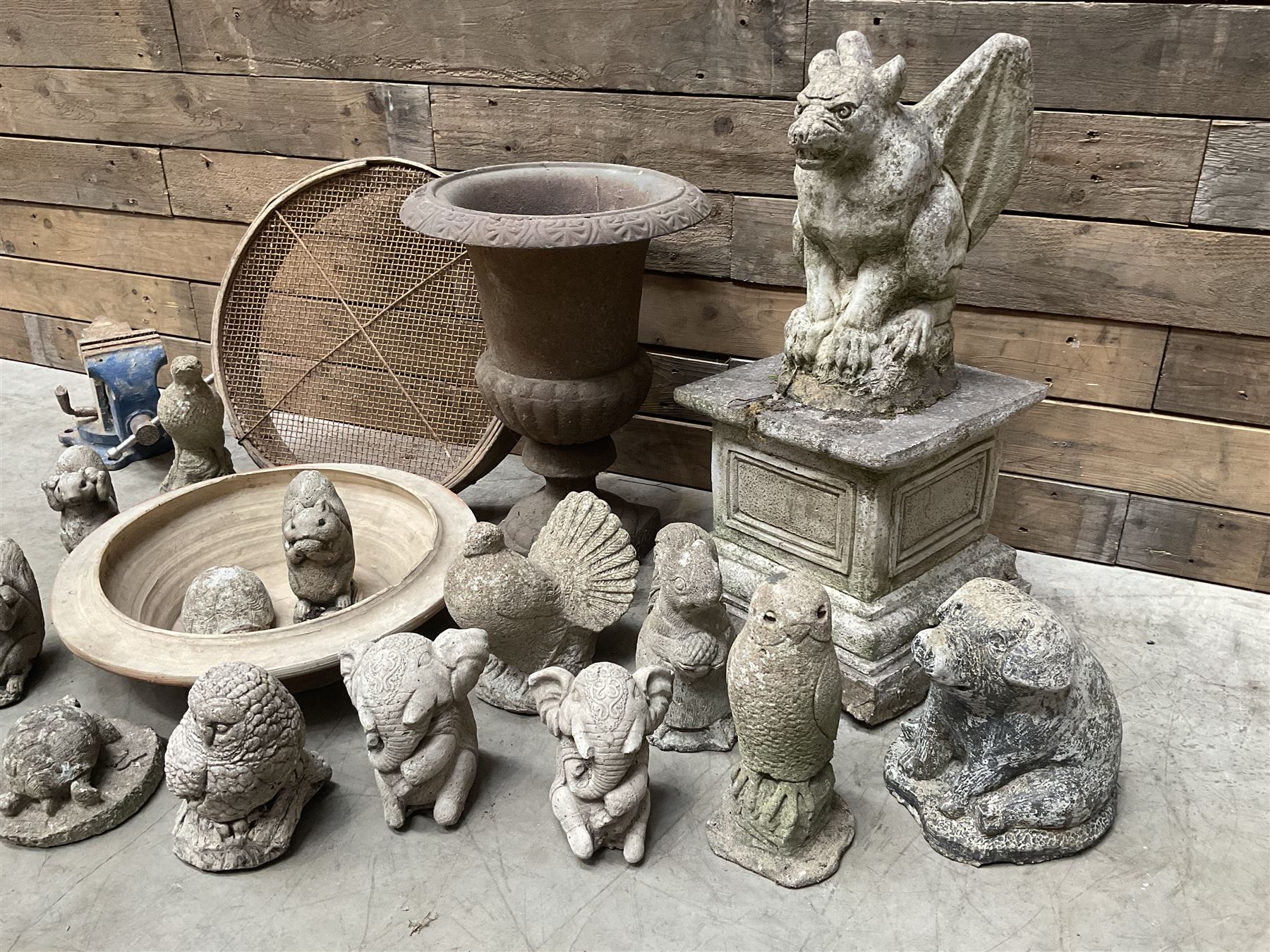 Small Victorian style cast iron urn, cast stone griffin on plinth, 13 garden figures, old vice and other items. 