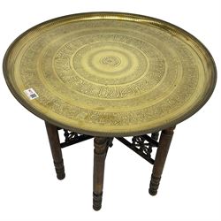 20th century Benares table, circular tray top with engraved decoration, on folding hardwood stand