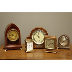  Early 20th century 'Elliot' walnut cased mantel clock, triple train movement with Westminster chime, another small 'Elliot' clock in oak case, early 20th century lancet shaped polished metal clock, Edwardian mahogany cased clock and a brass and bevel glazed carriage clock  