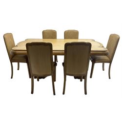 Early 20th century Art Deco walnut twin pedestal dining table, shaped top with thick crossbanding over a rounded edge, raised on two shaped pedestals (W187cm D107cm H76cm); and set of six matching dining chairs, the high back and sprung drop-in seat upholstered in walnut effect faux leather with reeded apron, raised on square supports (W47cm H97cm)