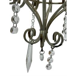 India Jane Interiors - six branch metal chandelier, the scrolled crown over circular bulbous body with six projecting branches, decorated with scroll work and glass pendants, in distressed white paint finish - ex-display/bankruptcy stock 