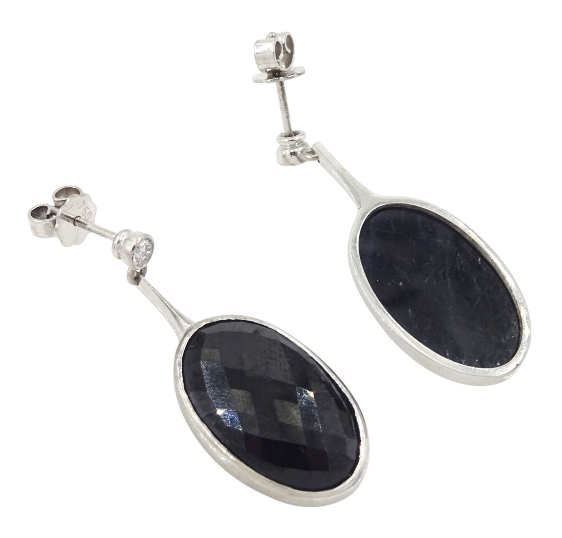 Pair of 18ct white gold sapphire and diamond pendant earrings, each stud set with a single round brilliant cut diamond, suspending an oval harlequin cut sapphire, hallmarked, total sapphire weight approx 31.30 carat