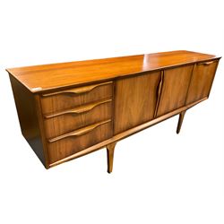 Jentique - mid-20th century teak sideboard, fitted with three drawers, double cupboard and fall front cupboard, raised on tapering supports