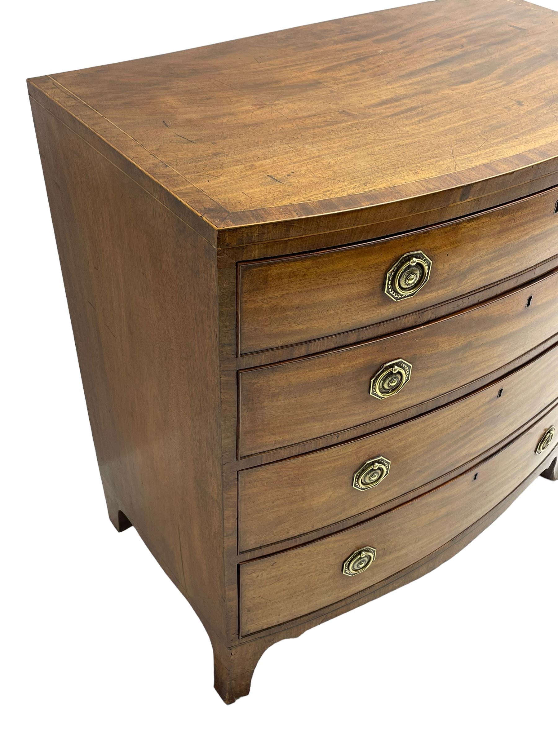 George III inlaid mahogany bow-front chest, fitted with four graduating drawers, octagonal plate and loop handles, shaped apron and splayed bracket feet