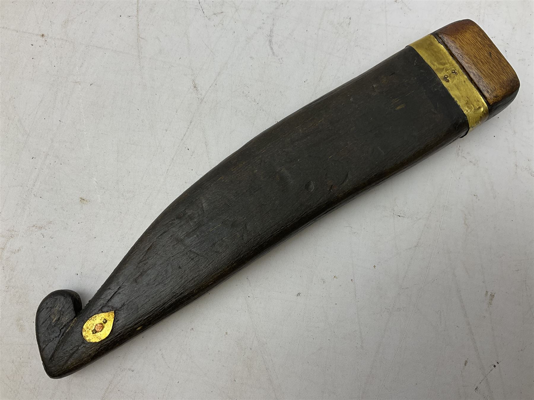 19th century Singhalese knife pia kaetta, the 20cm steel blade inset with yellow and white metal, with metal mounted carved pistol grip, in plain wooden scabbard L33cm overall