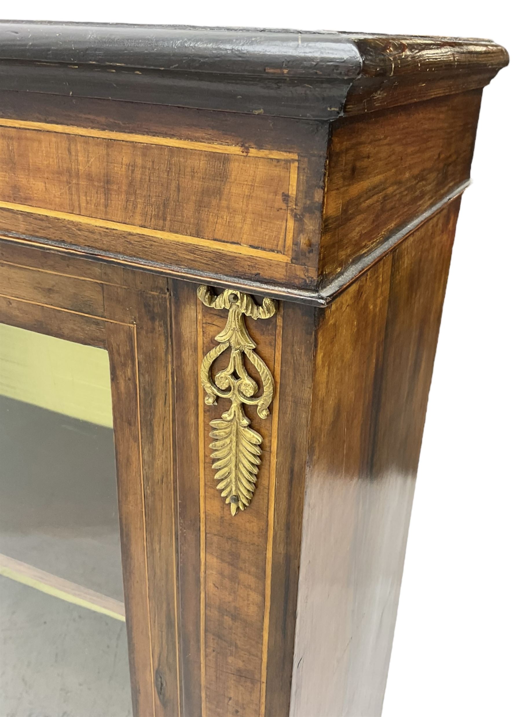 Victorian walnut pier cabinet, moulded rectangular top over inlaid frieze and uprights, enclosing by single glazed door, the interior fitted with two shelves, on shaped bracketed plinth base