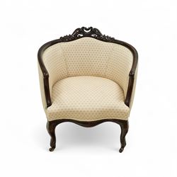 Victorian carved mahogany tub chair, upholstered in cream patterned fabric, with pierced foliate carved top rail, curved back and seat, serpentine seat rail, on cabriole front legs with brass castors