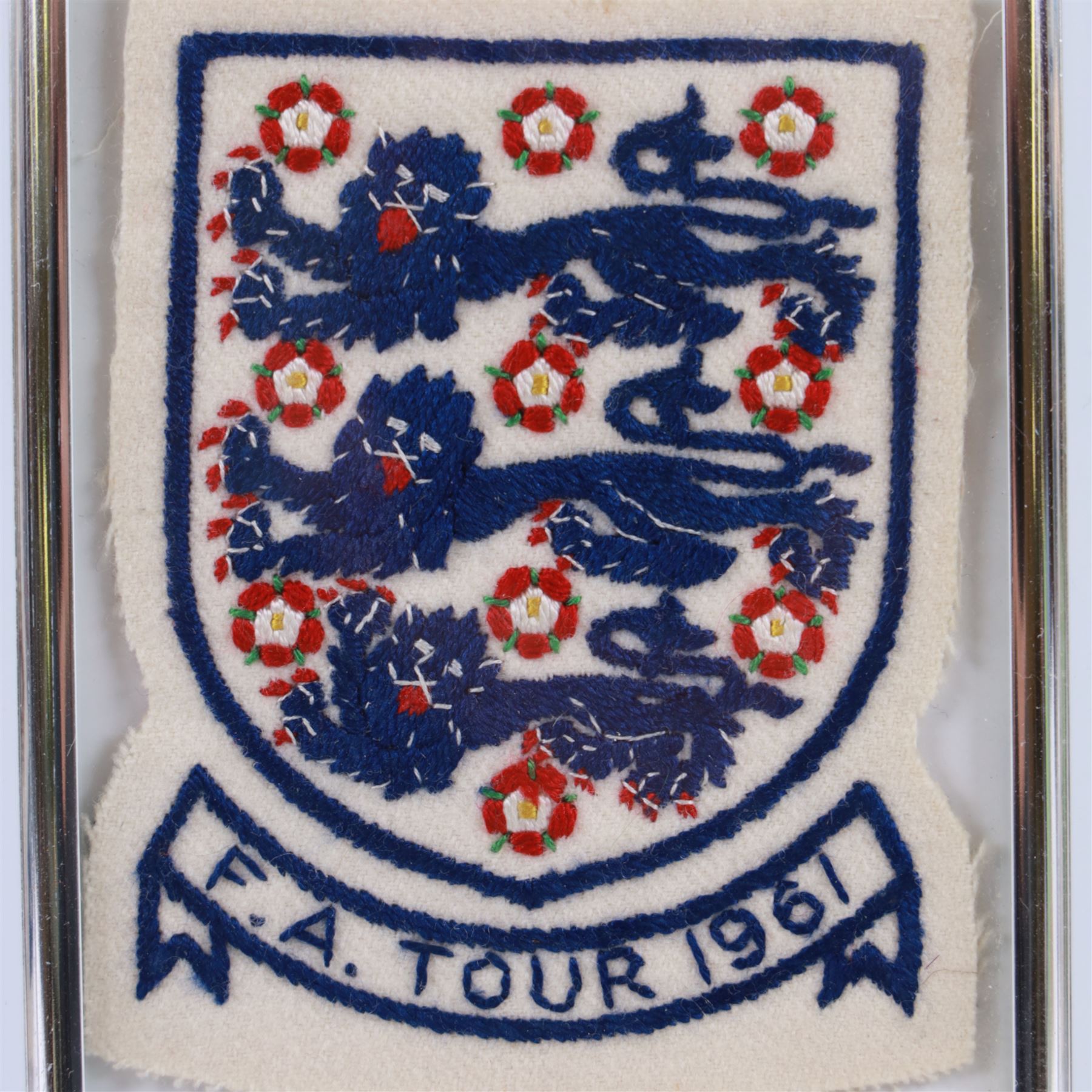 1960s three lions embroidered cloth badge from an England football shirt, reading F.A. Tour 1961, framed