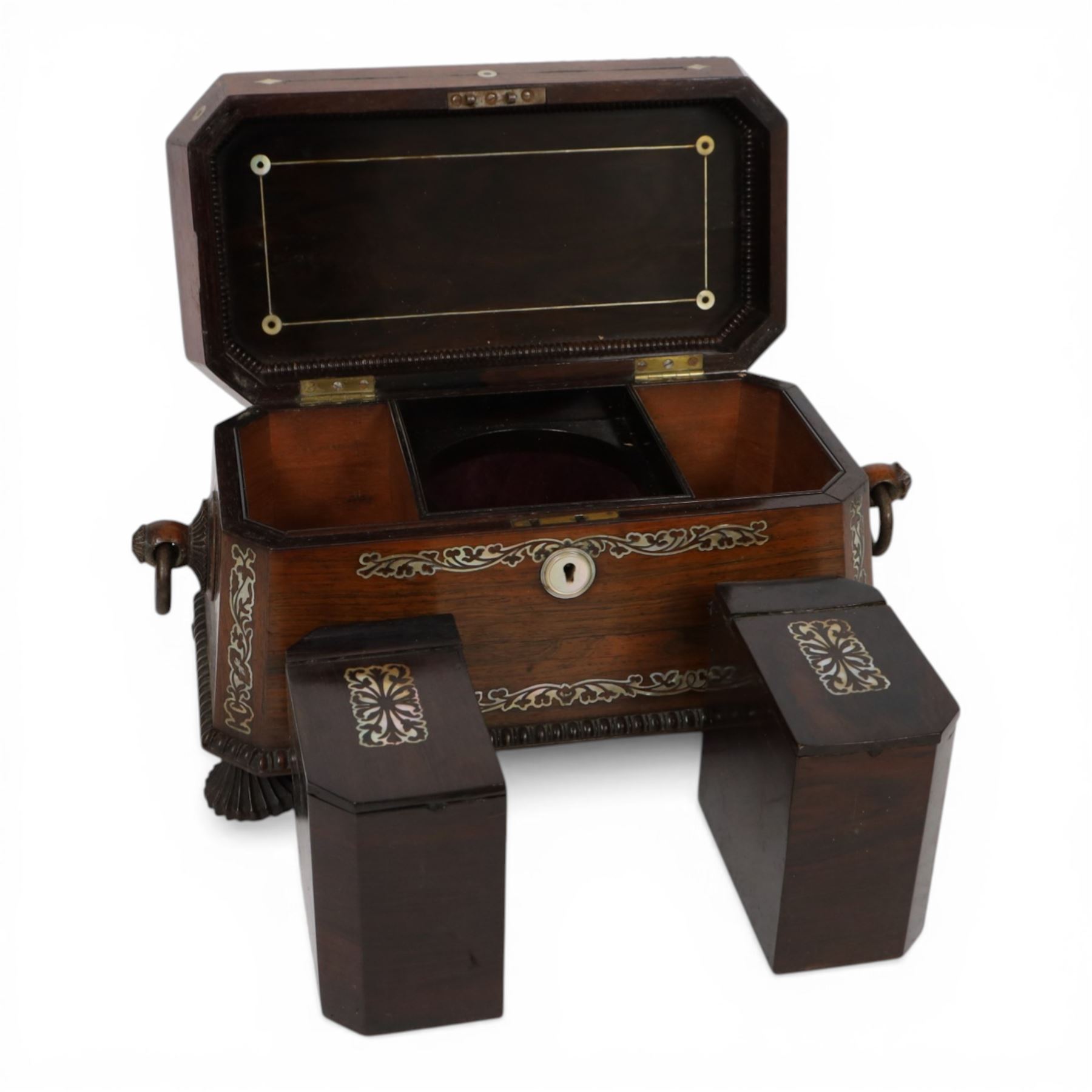 Tea caddy of sarcophagus form, inlaid with mother of pearl decoration,  the hinged lid opening to reveal two covered compartments, H24cm 