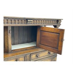 Jacobean design oak court cupboard, upper section with carved arched panelled cupboard door flanked by turned columns, beneath carved and moulded frieze, lower section fitted with two drawers over two cupboard doors with gothic arched panel decoration, raised on stile supports
