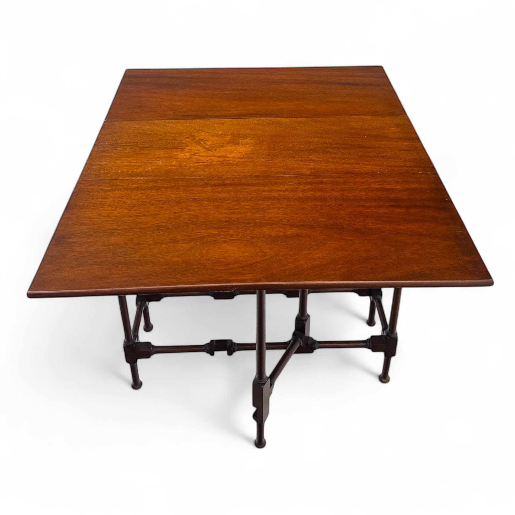 Set of two early 20th century mahogany occasional tables, comprising an oval example with under-tier and galleried shelf on swept supports, and a drop-leaf Sutherland table with turned gateleg supports and stretcher base (Oval H 74cm, W 57cm, D 86cm) (Sutherland H 71cm, W 30cm-94cm, D 76cm)