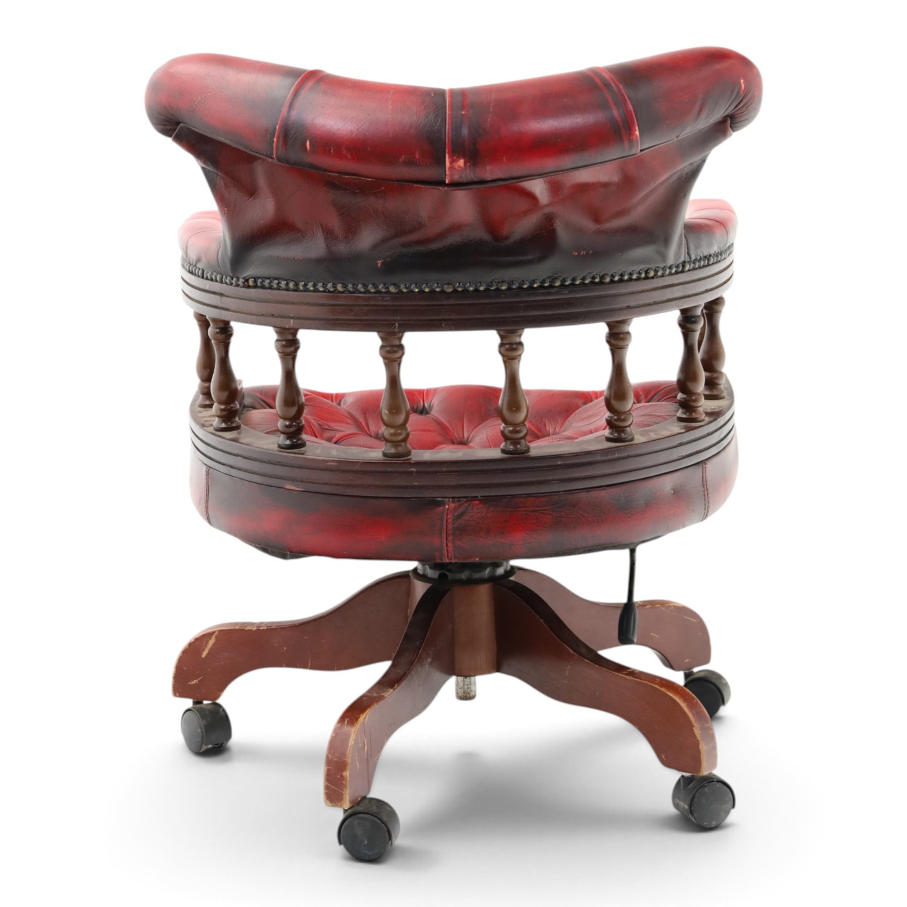Georgian design captains swivel desk chair, rolled cresting rail over open spindle back on swivel action, upholstered in buttoned oxblood leather