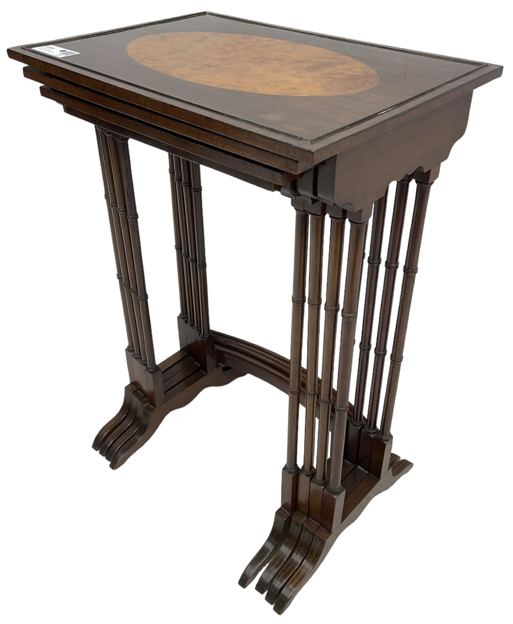 20th century inlaid mahogany quartetto nest of four tables, rectangular top inlaid with birdseye maple oval panel, ring turned supports on sledge feet