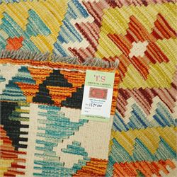 Chobi kilim with staggered diamond and stepped lozenge motifs in a palette of mustard, rust, teal, lilac and cream, the design enclosed by patterned guard stripes