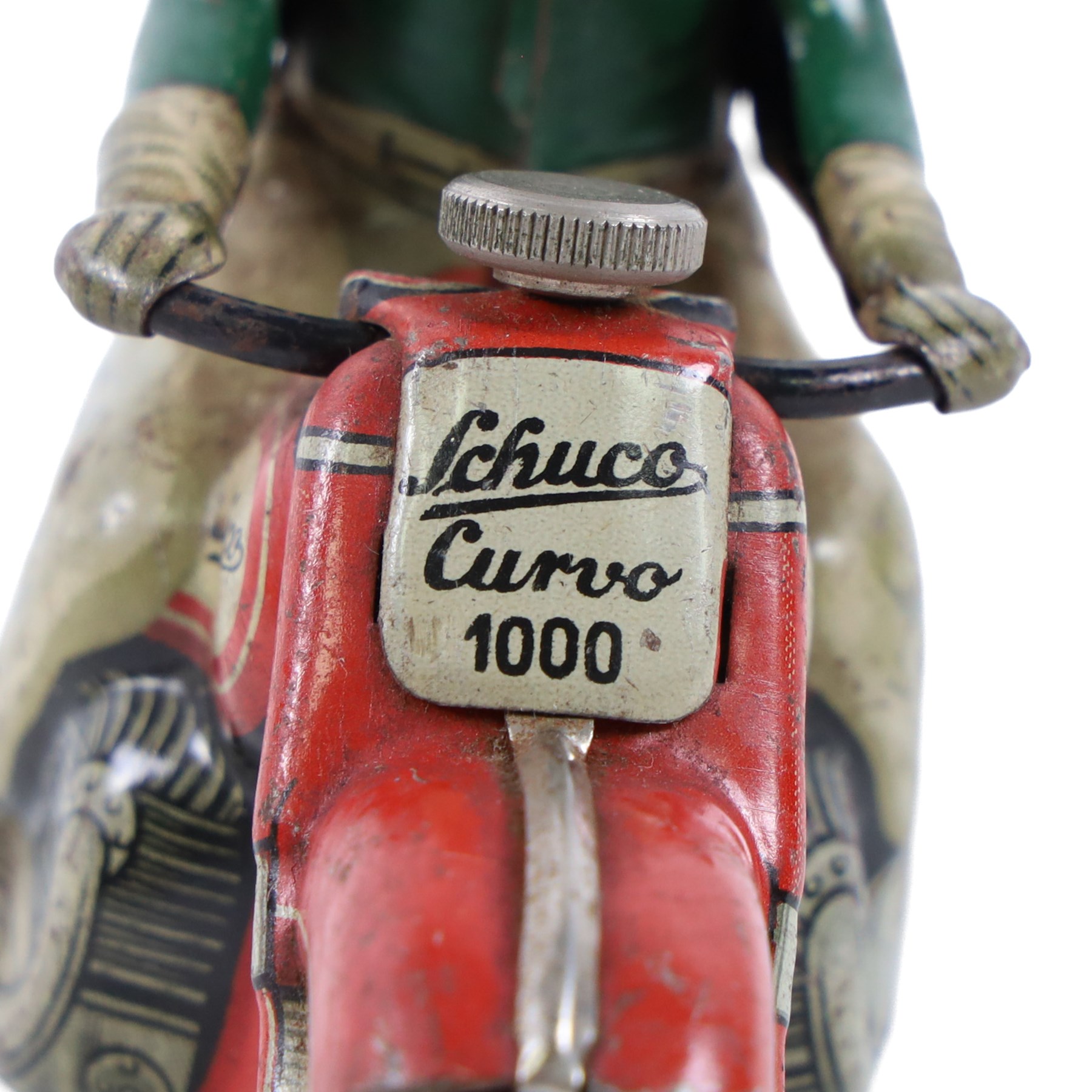 Schuco Curvo 1000 tinplate clockwork motorcycle, in red and cream, with rider in green jacket