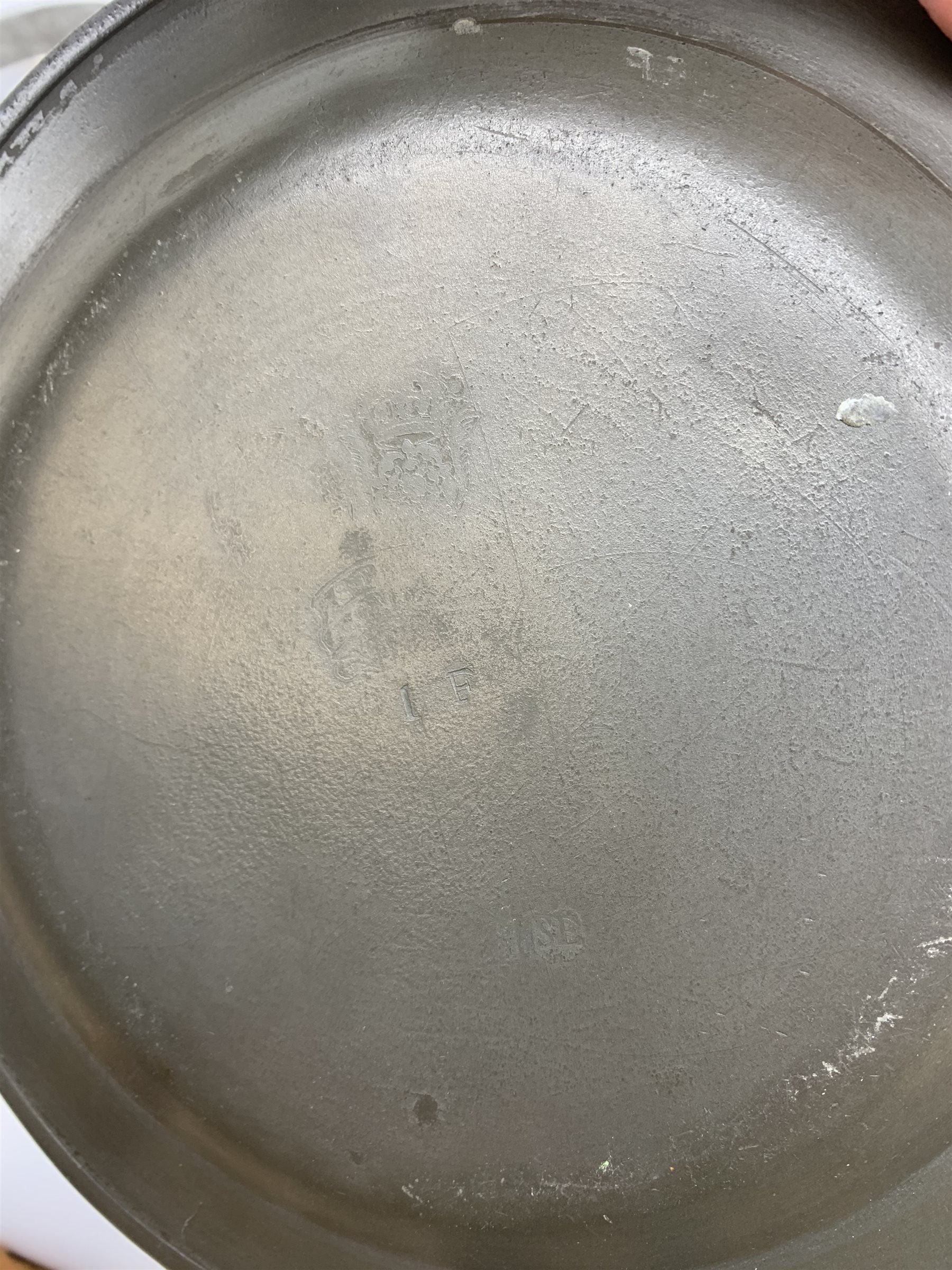 Collection of early 18th century pewter, comprising three large chargers, and seven plates, with various marks and touch marks verso, including the Crowned Rose and shield pseudo 'hallmarks', chargers D46cm and D42cm, plates D23cm.