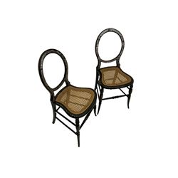 Pair Victorian balloon back bedroom chairs, black lacquered and decorated with mother of pearl in Greek key design, cane seats, on turned supports
