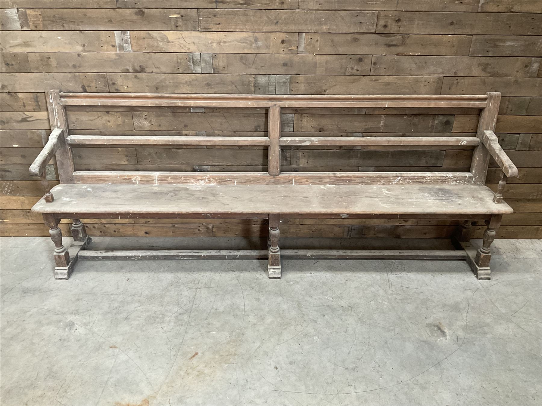 Victorian pitch pine bench pew, turned arms and legs, rail back with plank seat, 249cm