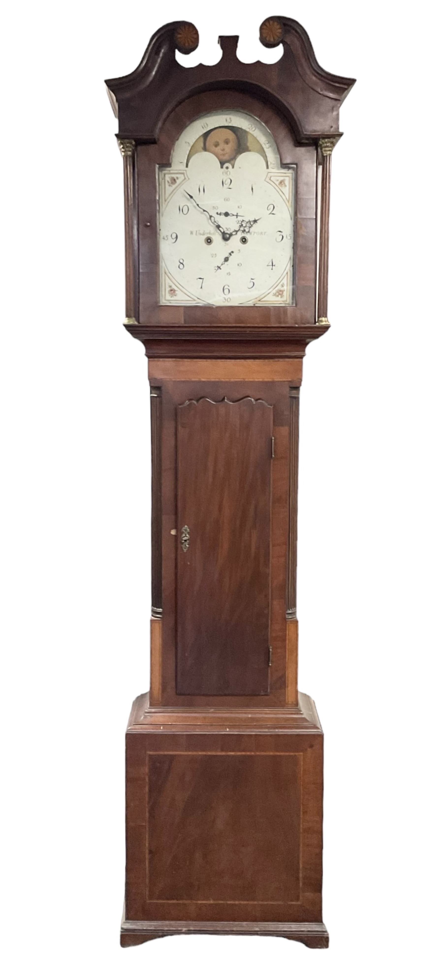 William Underhill of Newport (Shropshire) - Early 19th century mahogany longcase clock c1820,  with a swans necked pediment and inlaid paterae, break arch hood door flanked by reeded pilasters with Corinthian capitals, trunk with quarter columns and a wavy topped door, square plinth with inlay raised on a shaped plinth, painted dial with floral spandrels and moon phase disc to the arch, Arabic numerals and matching steel hands with subsidiary date and seconds hand, dial pinned directly to an 8-day rack striking movement, sounding the hours on a cast bell. With pendulum, weights and key.