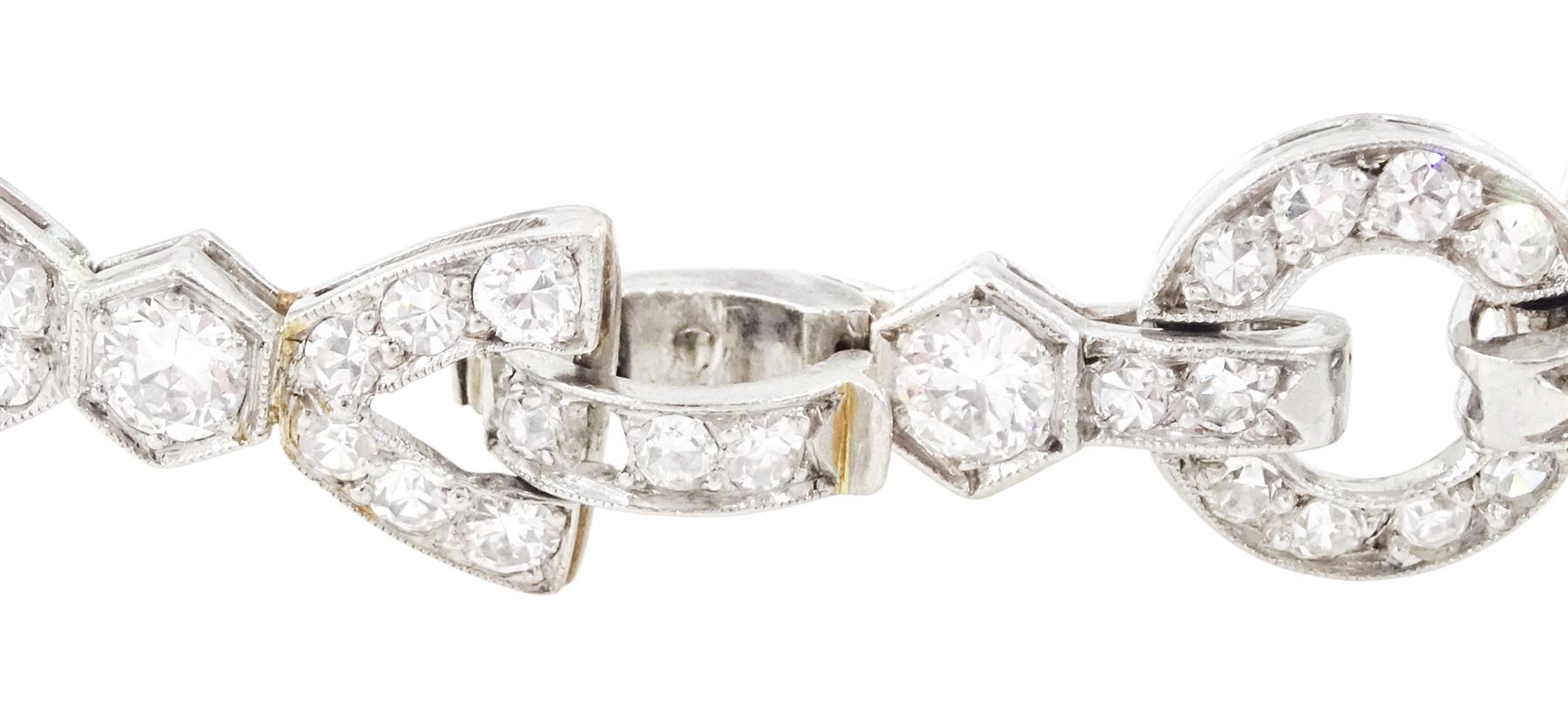 Art Deco platinum diamond bracelet, circa 1920, articulated openwork circular and geometric links, milgrain set with old cut diamonds and baguette cut diamonds, total diamond weight approx 3.85 carat