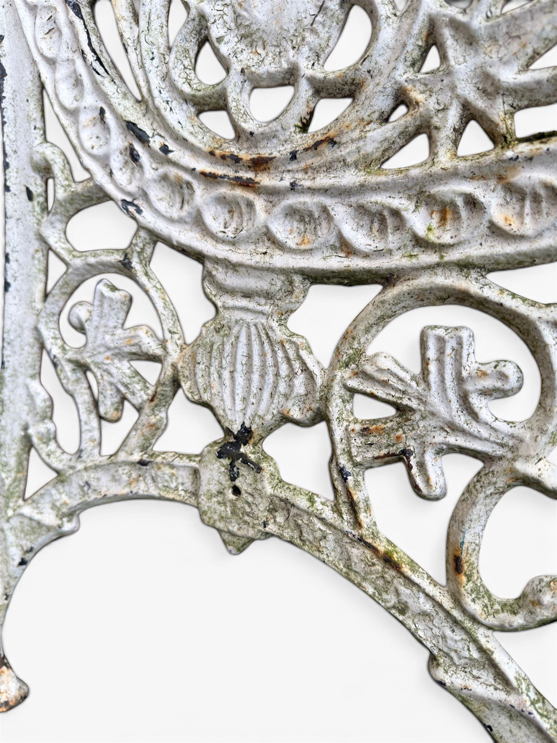 Pair of ornate painted cast iron bench ends, painted in white finish