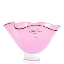 Gillies Jones pink glass bowl with crimped black rim upon a pedestal foot, H11cm