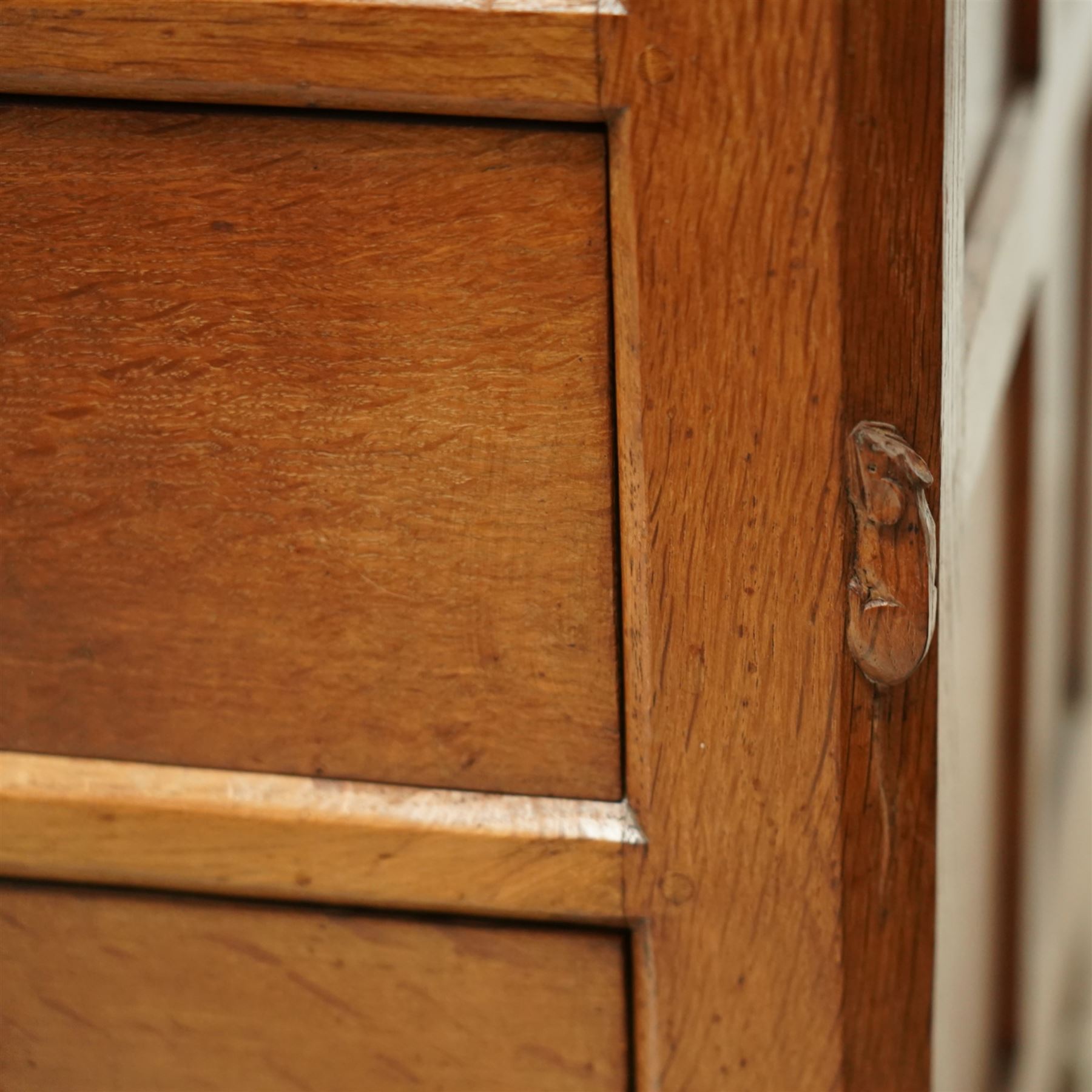 Mouseman - Oak chest of drawers, rectangular adzed top with raised gallery, two short over two long drawers with turned handles, raised on octangonal supports, carved mouse to the right edge, by the workshop of Robert Thompson, Kilburn.

Provenance - this lot comes to us for sale from direct descent of Robert Thompson. Thompson is the great grandfather of the vendor