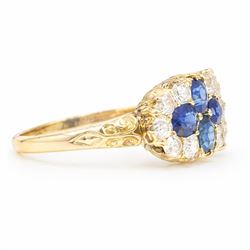 Victorian sapphire and diamond cluster ring, four oval cut sapphires, surrounded by eight old cut diamonds, with scroll design shoulders