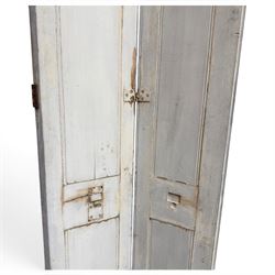 Set of three French 19th century painted pine folding window shutters of tall form, each comprising two hinged leaves with three graduated raised and fielded panels, in antique cream-painted finish