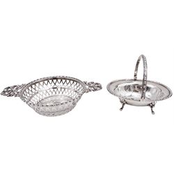 Two early 20th century silver bon bon dishes, the first example of circular form with pierced latticework sides and twin bow shaped handles, hallmarked Synyer & Beddoes, Birmingham 1912, D10.3cm, the second example of oval form with swing handle and bead and dart rim, upon four palmette mounted pad feet, hallmarked Sibray, Hall & Co Ltd, Sheffield 1919, W9.5cm, approximate total weight 4.89 ozt (152.3 grams)