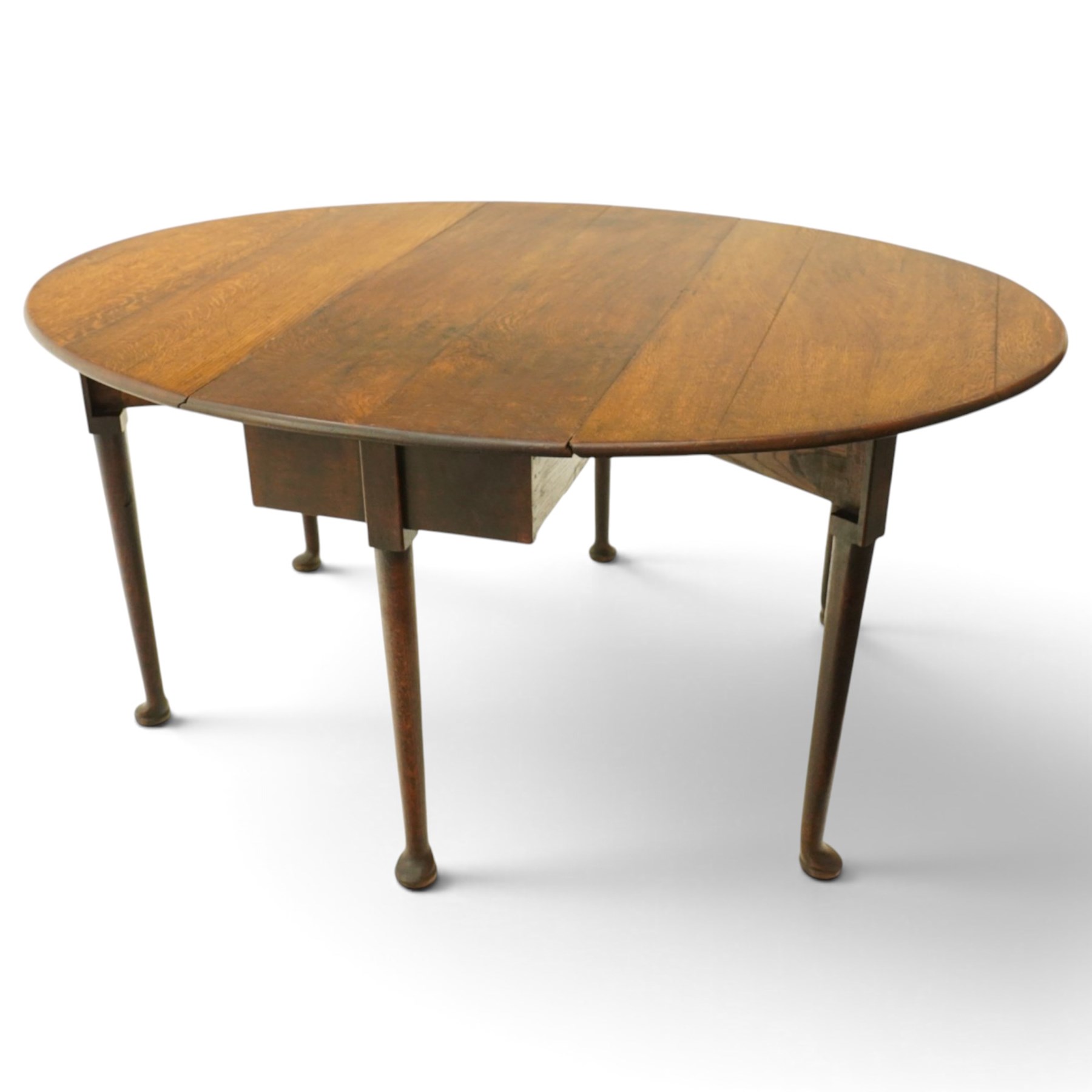 George III oak six-legged drop-leaf dining table, the oval drop-leaf top over six gate-leg supports with pad feet