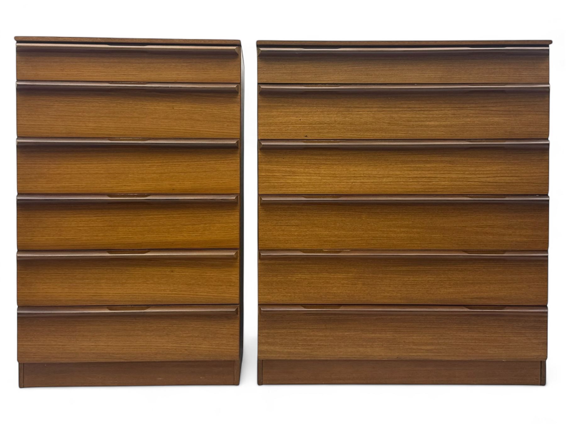 Avalon - two mid-20th century teak chests, with rectangular top above six graduated drawers, each fitted with recessed sculted pulls, raised on a flush plinth base.

(W 82cm D 55cm H 97cm)
(W 82cm D 55cm H 97cm)
