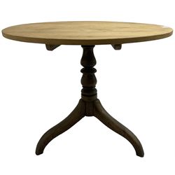 Early 19th century pine and elm tripod table; circular tilt-top over turned column and three splayed supports