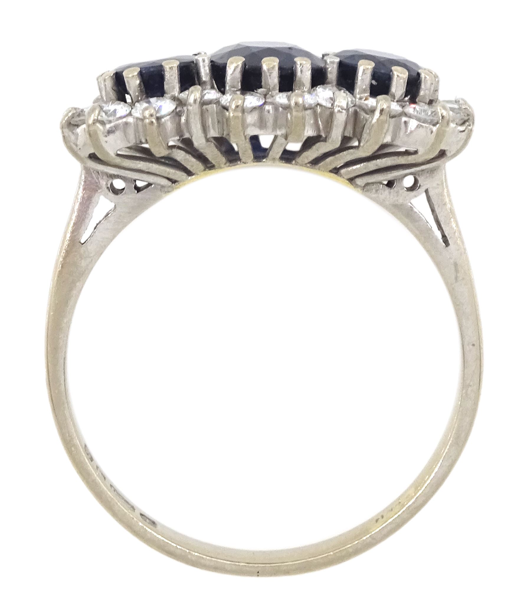 18ct white gold three stone oval and round cut sapphire and round brilliant cut diamond cluster ring, London 1986, total sapphire weight approx 1.80 carat, total diamond weight approx 0.60 carat