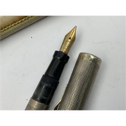 Three parker fountain pens, one example with 14ct gold plated cap and personal engraving, in Parker 51 box, together with a silver Sampson Mordan Everpoint propelling pencil with personal engraving and a silver cased fountain pen with 14ct gold nib and a souvenir bronze Dollfus-Mieg medallion, awarded to John G Sedorski, in fitted case 
