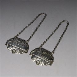 Silver bottle coaster, of circular form with turned wooden centre and pierced sides, hallmarked LGS, London 1977, together with two decanter labels, each with embossed grape vine decoration engraved Scotch and Sherry, hallmarked 