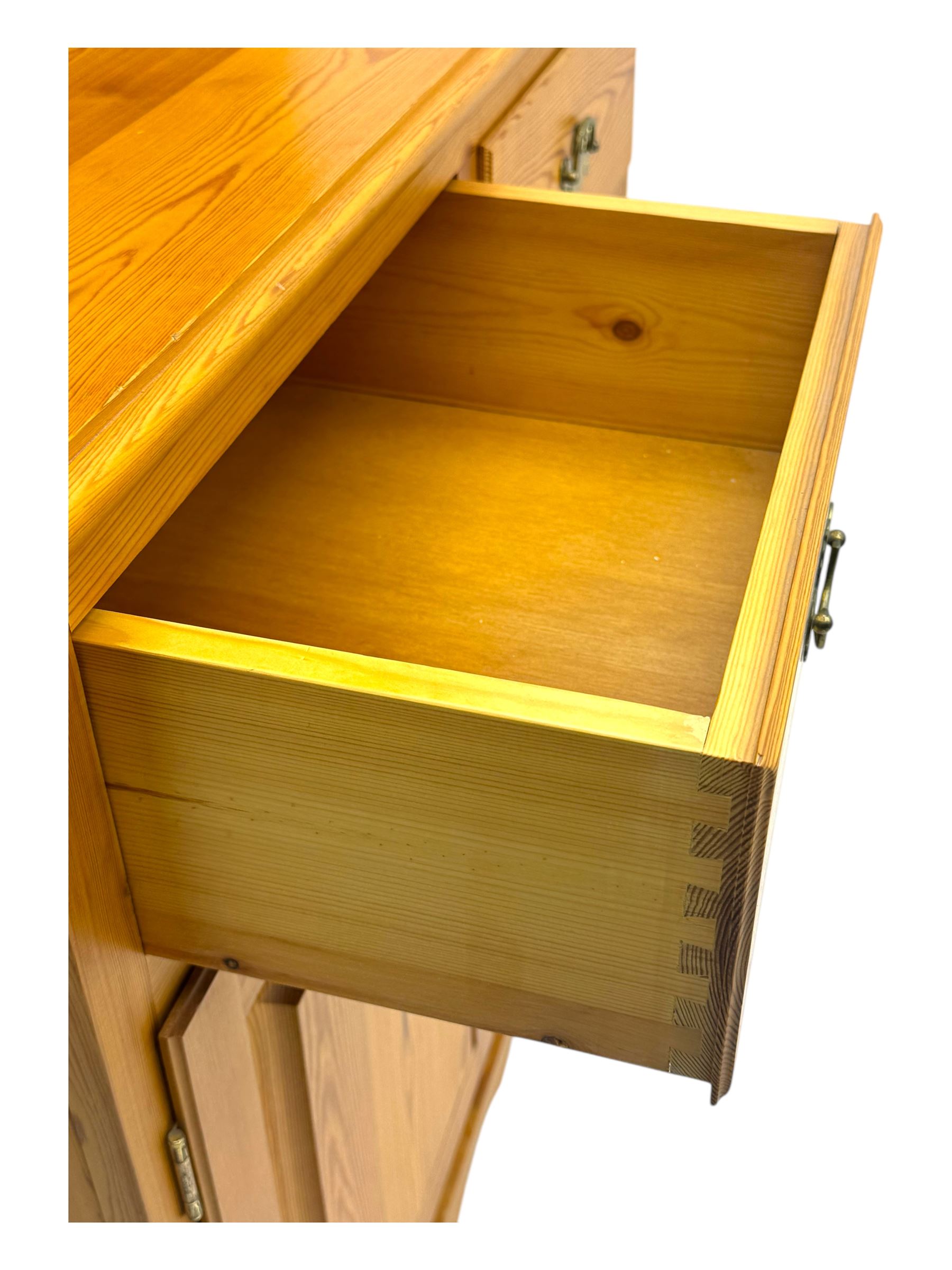 Victorian design pine dresser, projecting moulded cornice over scalloped frieze and two open shelves, base fitted with two drawers over double cupboard, on shaped plinth base