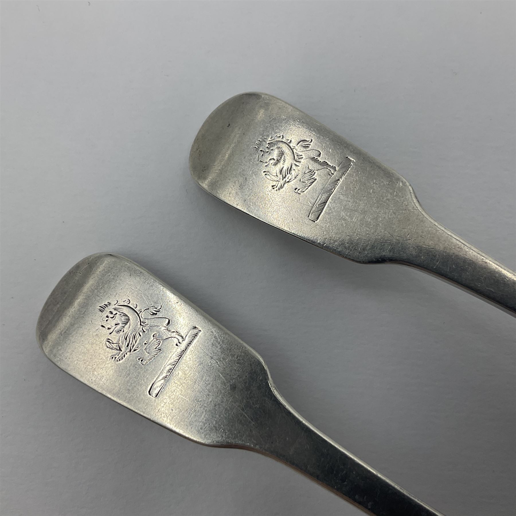 Pair of George III York silver Fiddle pattern dessert spoons, each engraved with a rampant lion crest, hallmarked James Barber & William North, York 1789