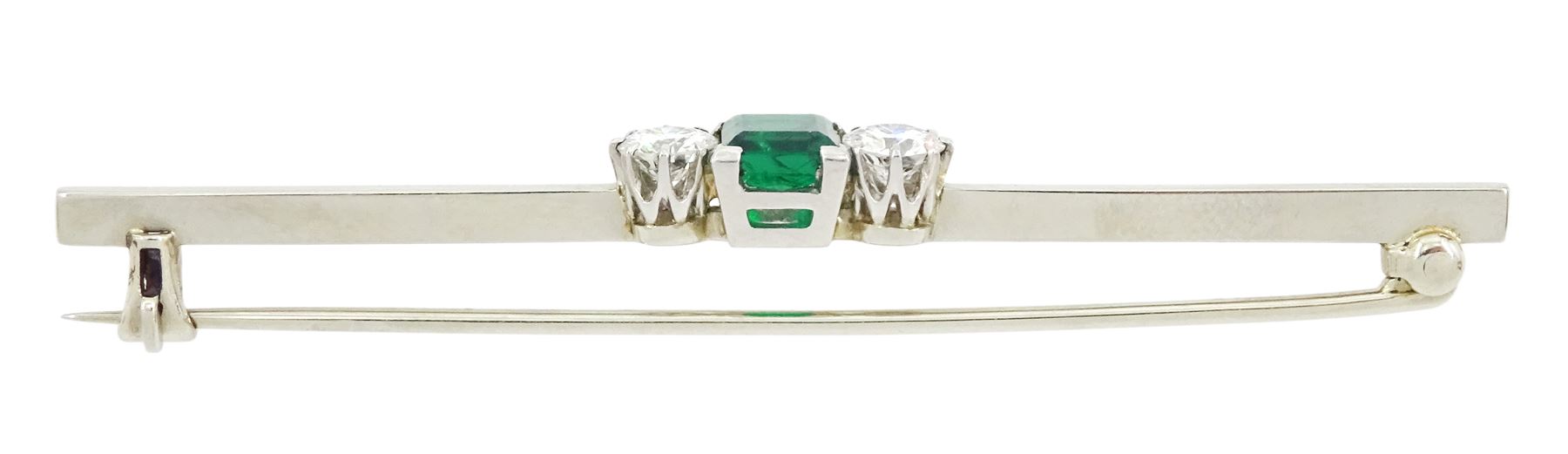 18ct white gold three stone square cut emerald and round brilliant cut diamond brooch, emerald approx 0.50 carat, total diamond weight approx 0.50 carat, in velvet and silk lined case by John Hall, Manchester