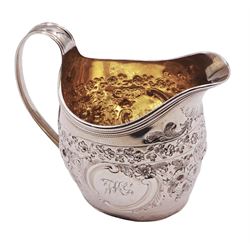 George III silver cream jug, with curved handle, later embossed foliate decoration, and gilt interior, hallmarked Robert Hennell I & David Hennell II, London 1800, H9.5cm, approximate weight 4.01 ozt (124.8 grams)