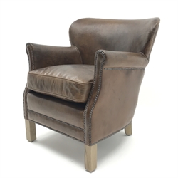  Club armchair upholstered in antique brown leather with low shaped back, W67cm, H74cm, D72cm  