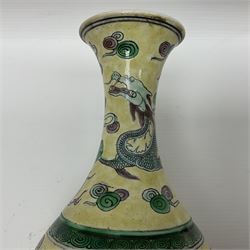 20th century Chinese Famille Verte vase, of slender ovoid form with tapering neck and flared rim, decorated with green and grey enamel with dragons chasing flaming pearls amongst auspicious clouds upon a yellow ground, H30cm