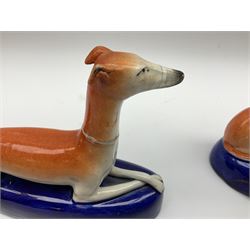 Pair of Staffordshire recumbent greyhound pen holders 