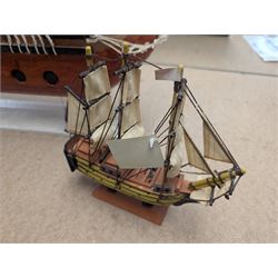 Wooden model ship 'Mayflower', together with a similar smaller example, largest H56cm